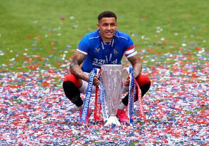 James Tavernier with Scottish Premier League Trophy on Ibrox pitch