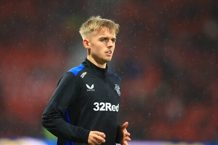 Ross McCausland wearing black Rangers football kit